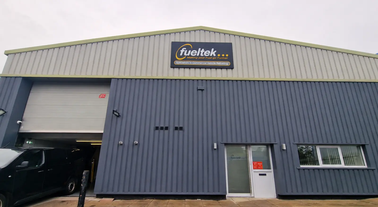 Exterior of Fueltek's Blackburn building with sign, loading bay and entrance