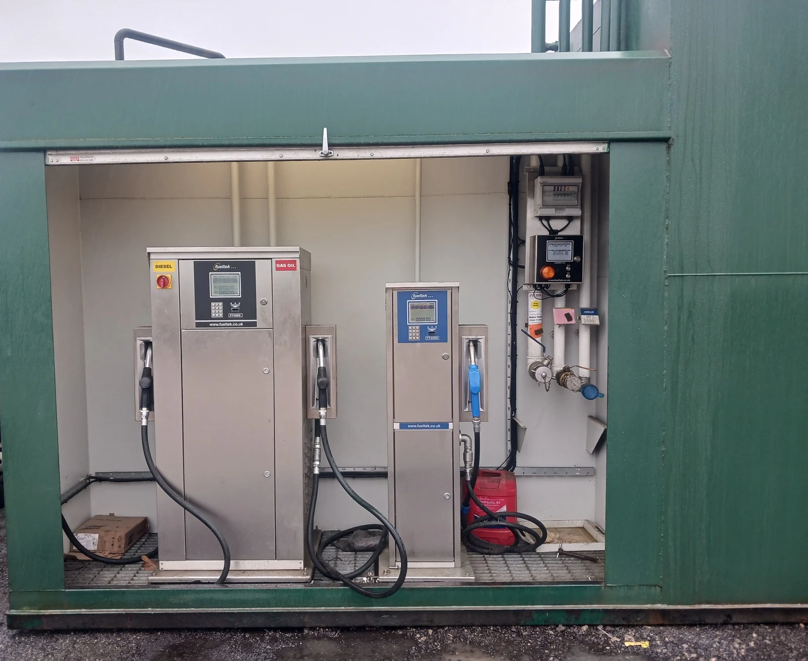 Fueltek dispensing and tank-monitoring equipment installed inside an open tank equipment bay.