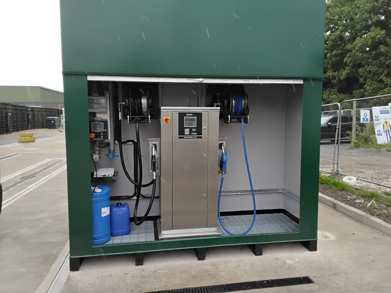 Open fuel tank equipment bay containing a dispenser and monitoring controls.