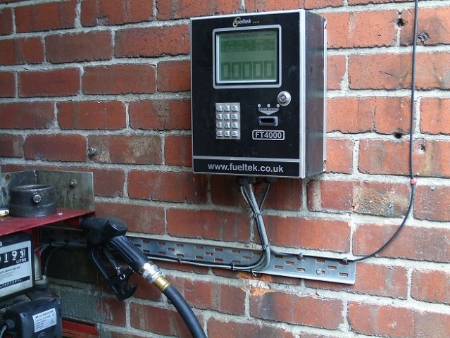 Fueltek fuel management system attached to a brick wall