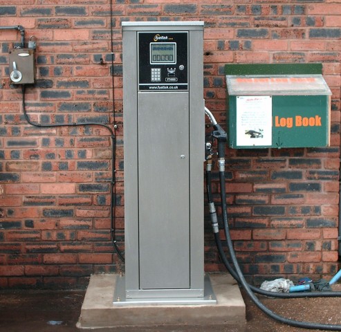 Fueltek fuel pump in front of a brick wall at Harlow Brothers Headquarters