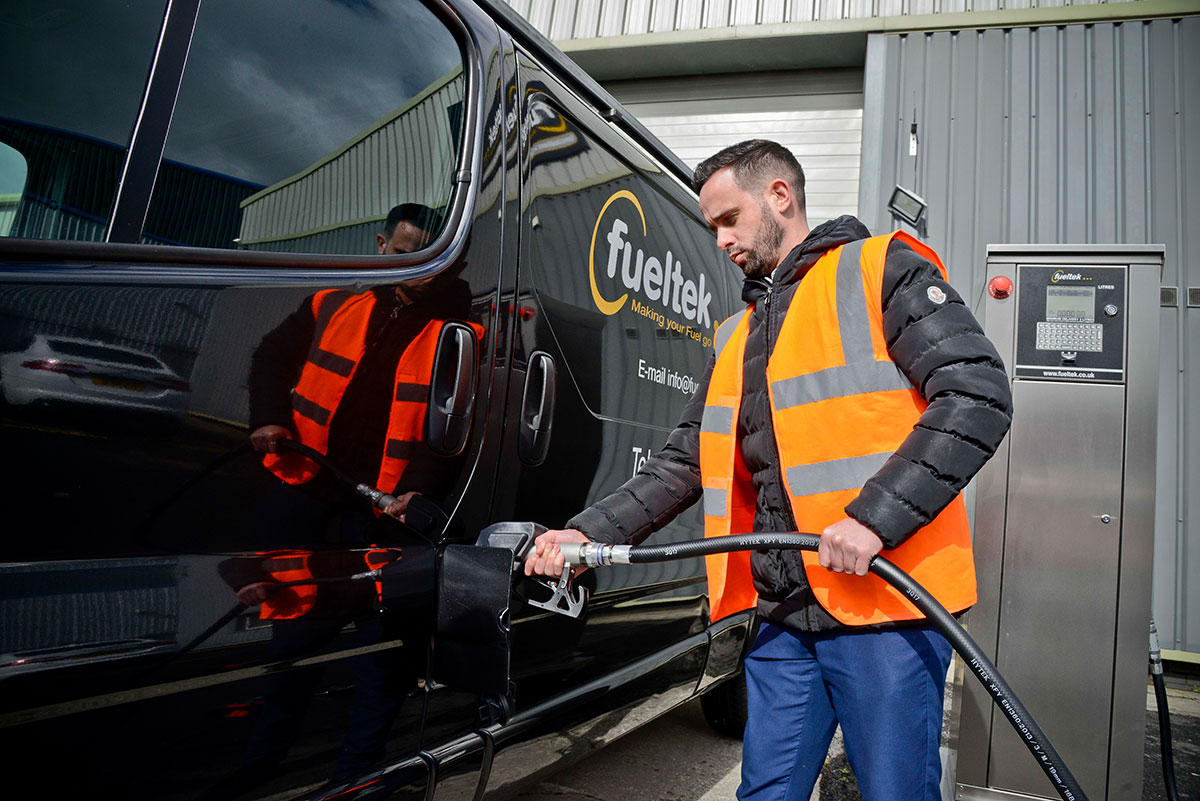 Person filling up Fueltek van using a Fueltek fuel pump