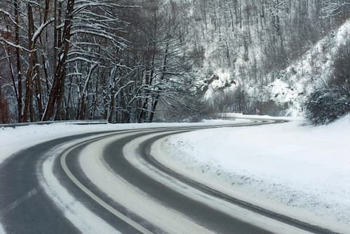 winding road with tyre tracks through the snow