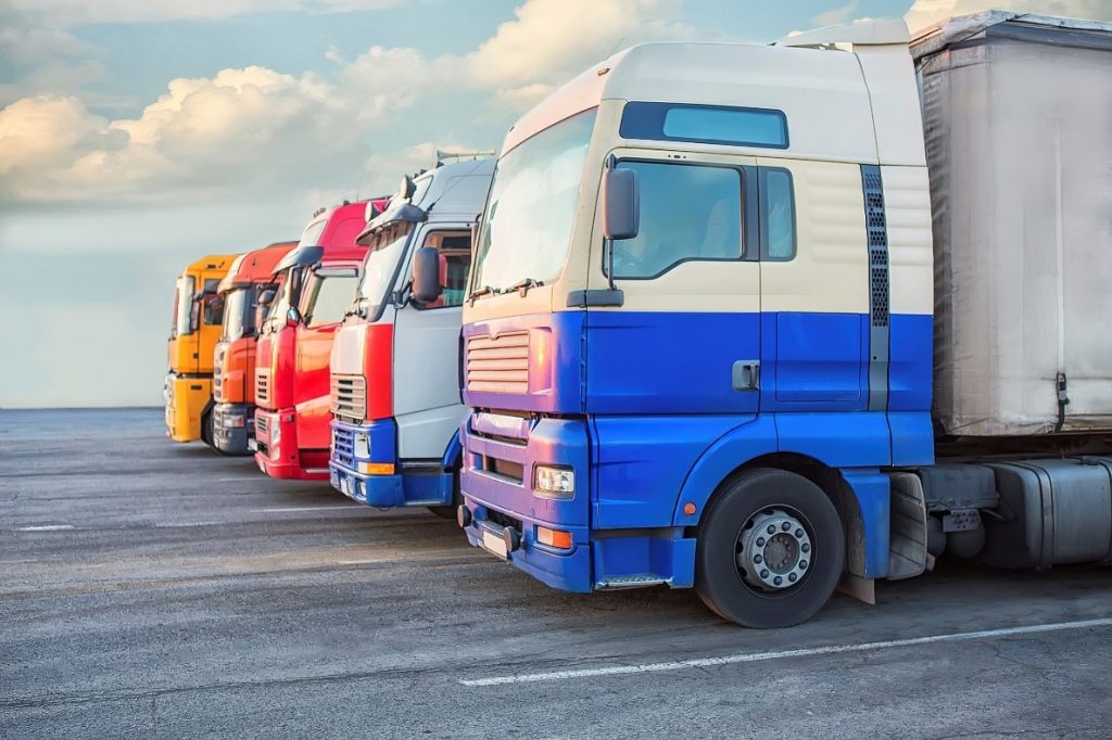 Colourful fleet of commercial trucks lined up ready to set off 