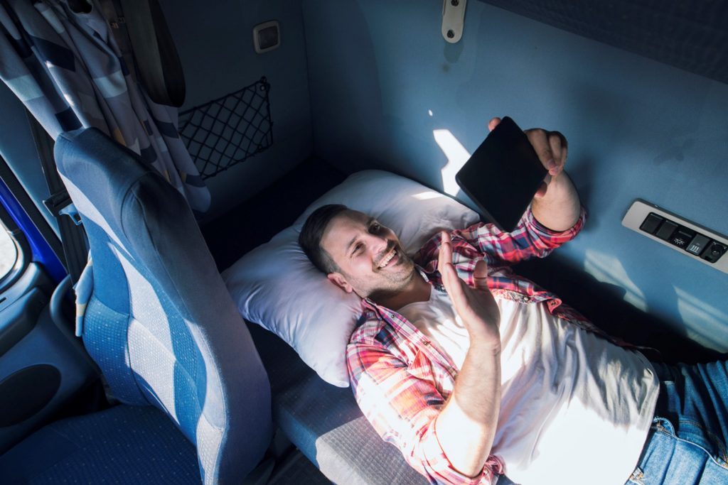 man in bed smiling on the phone