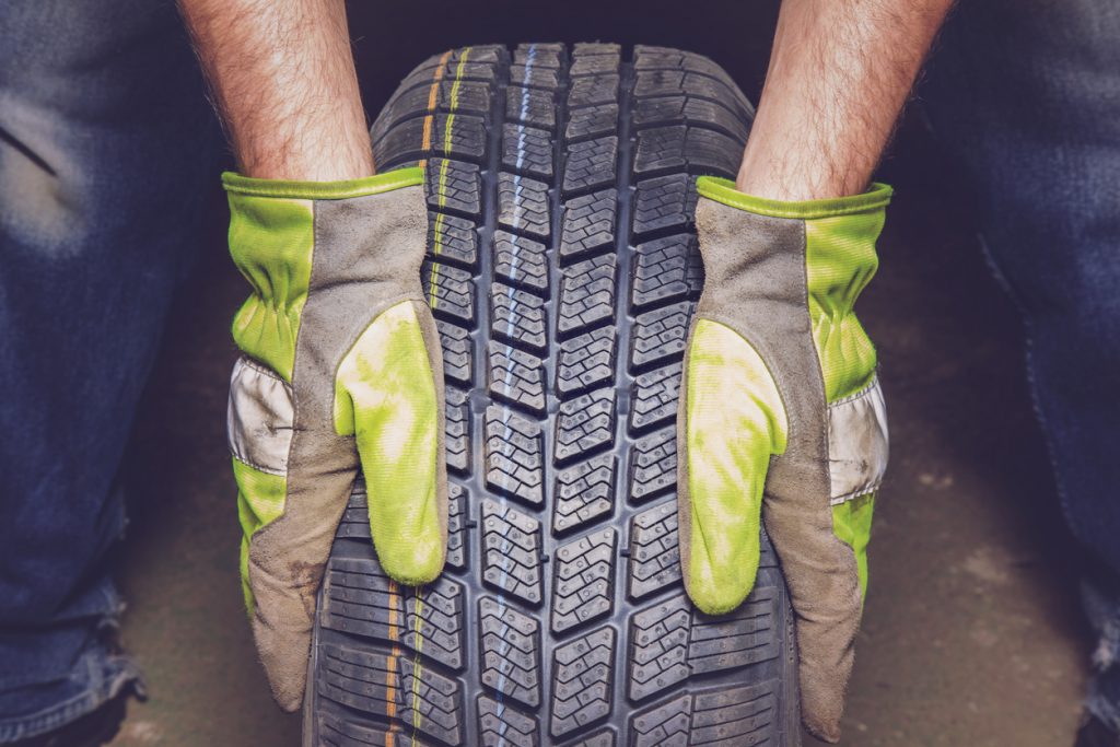 man holding a tyre