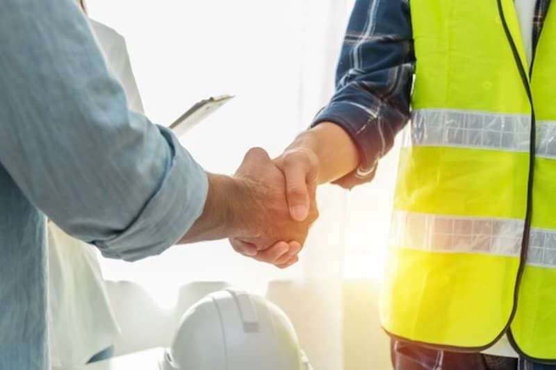 Commercial fleet manager shaking engineer hand