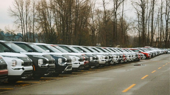 A row of cars parked in a parking lot