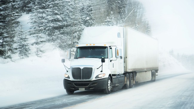 A truck driving on a snowy road